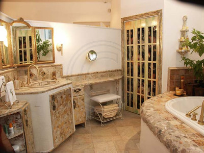 Bathroom suite with handprinted tiles, custom glass cantilevered door & gold leafed woodwork