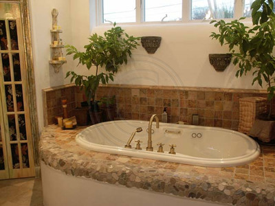 Hand painted tiles surround Jacuzzi tub